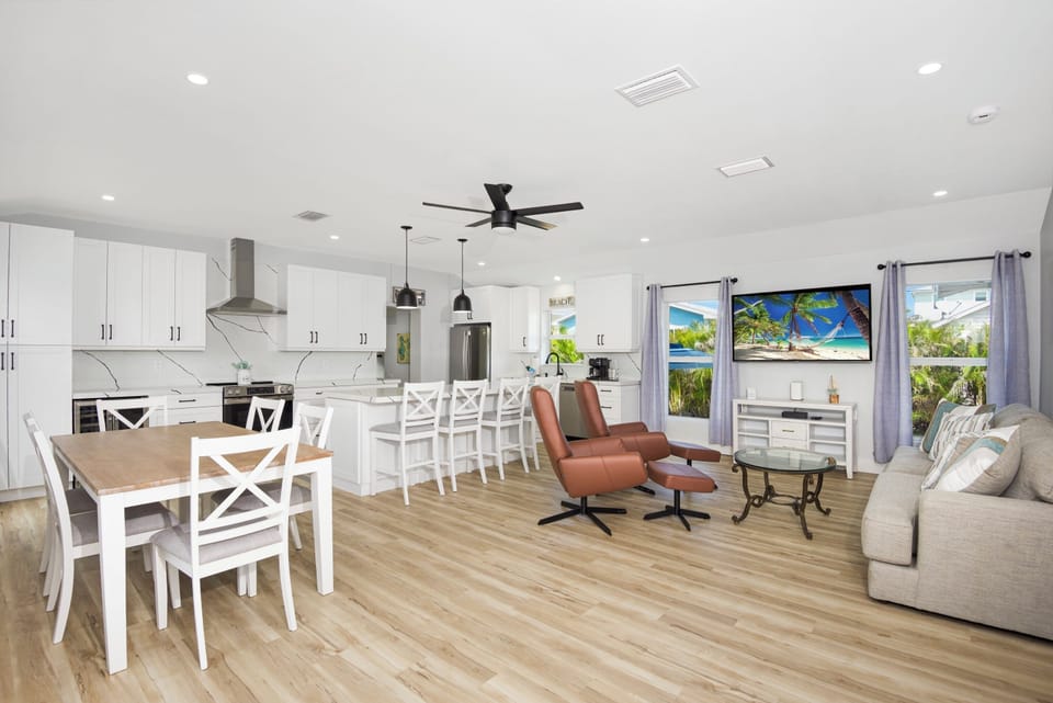 Open concept kitchen leading to living room with two comfy recliner chairs