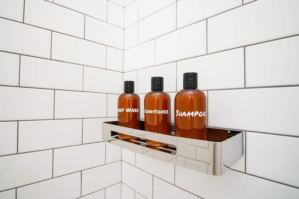 Hotel-style shower with complimentary toiletries neatly displayed—clean, modern, and thoughtfully prepared for your stay.
