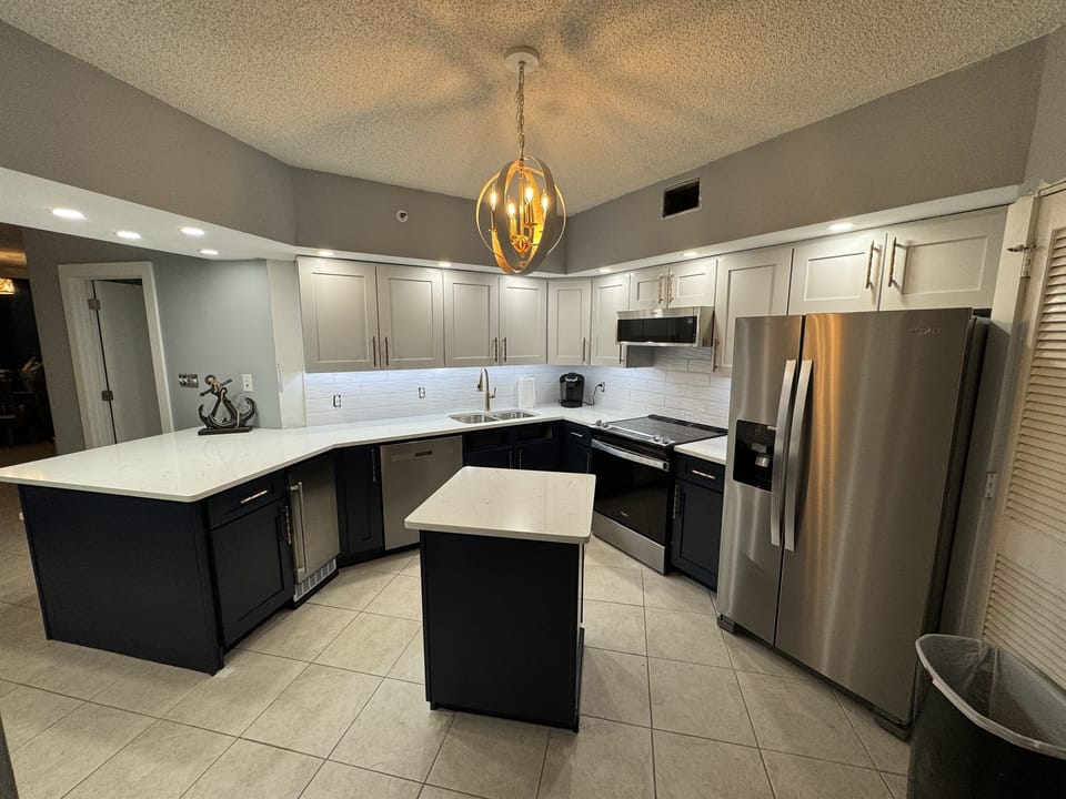 Newly remodeled Coastal Kitchen features all new Whirlpool stainless appliances including ice maker, dishwasher, sink, faucet, oven, microwave and refrigerator.