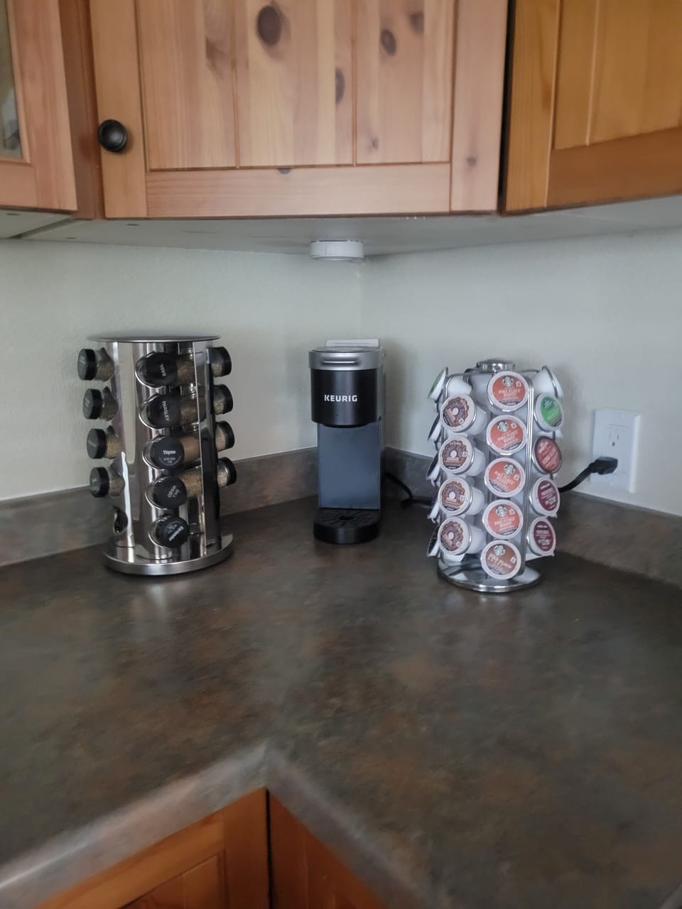 A Keurig coffee maker, K-cups and spices are provided. 