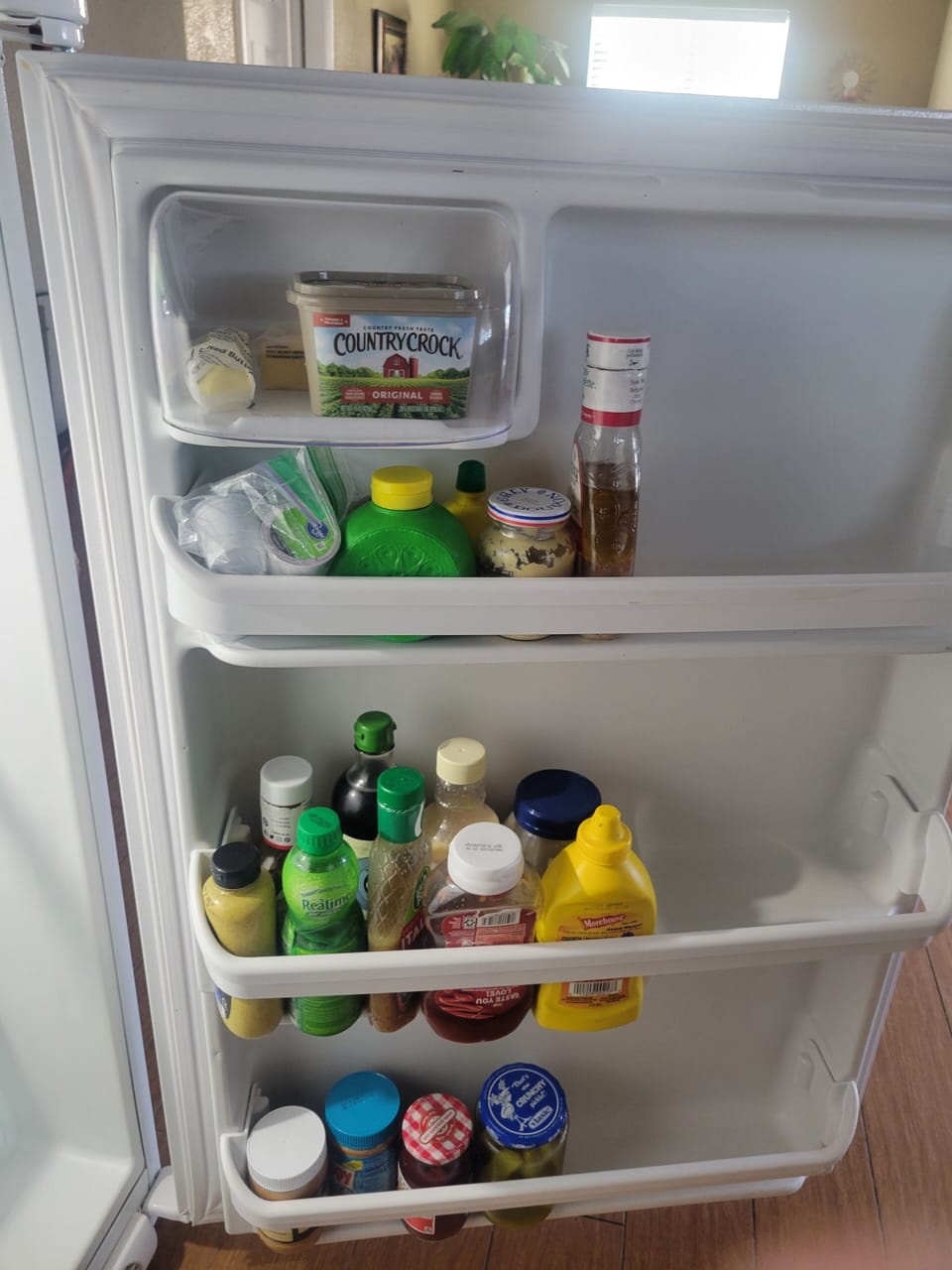 Inside of fridge.  We provide catsup and mustard.  Sometimes, there's more!