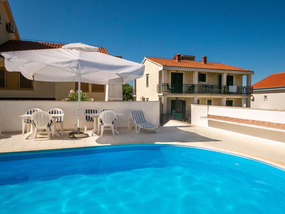Water, Sky, Property, Building, Swimming Pool, Plant, Azure, Shade, Outdoor Furniture, Sunlounger