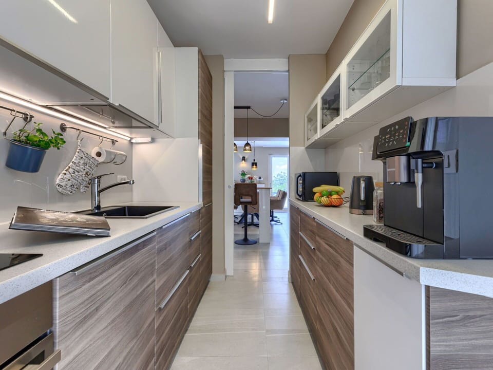 Kitchen, Countertop, Interior Design, Cabinetry, Kitchen Appliance, Flooring, Furniture, Major Appliance, Wood, Light Fixture