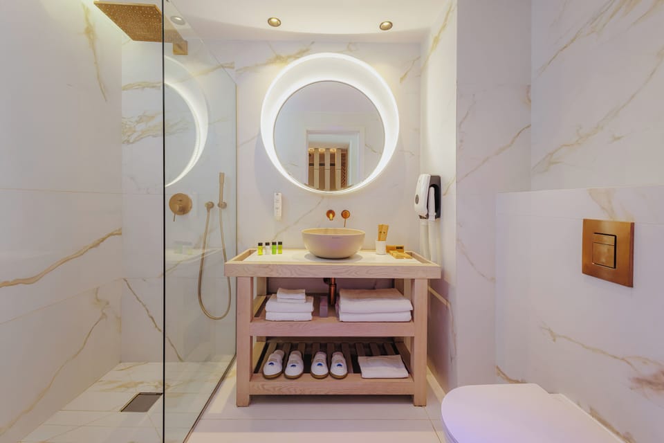 Premium Suite, Partial Sea View | Bathroom | Eco-friendly toiletries, hair dryer, slippers, towels