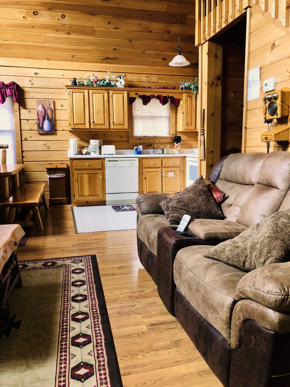 View into living room, kitchen area & dining table from front porch entry.
