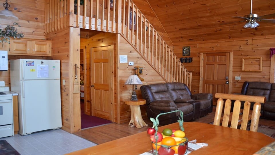 The living room and front door of the cabin on the far wall. 