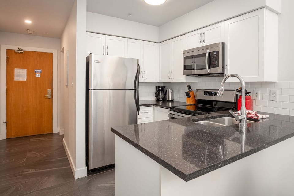 Fully equipped kitchen with granite counters & stainless steel appliances