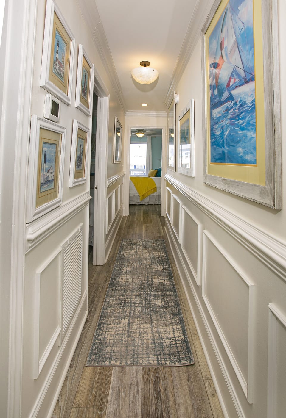 From the entry through a gallery of lighthouses to the 2 bedrooms & baths.