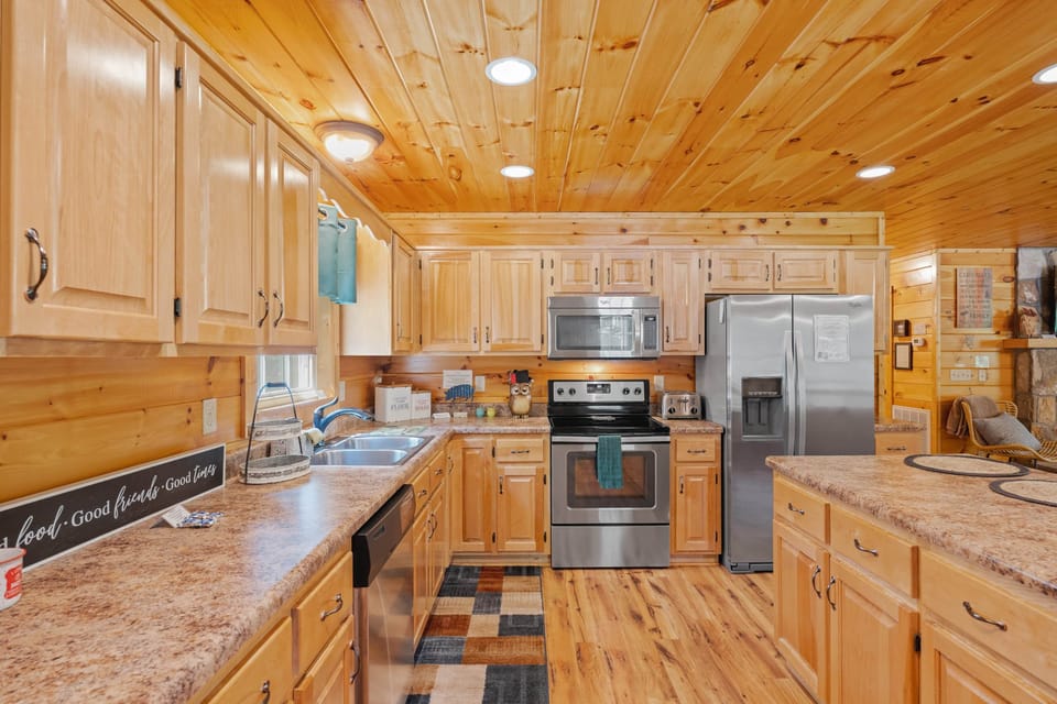 Spacious kitchen w/hand-crafted birch cabinetry & stainless appliances. (1)