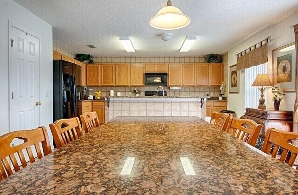 Kitchen table of 6 seats, granite counter top, pantry, open to family room.