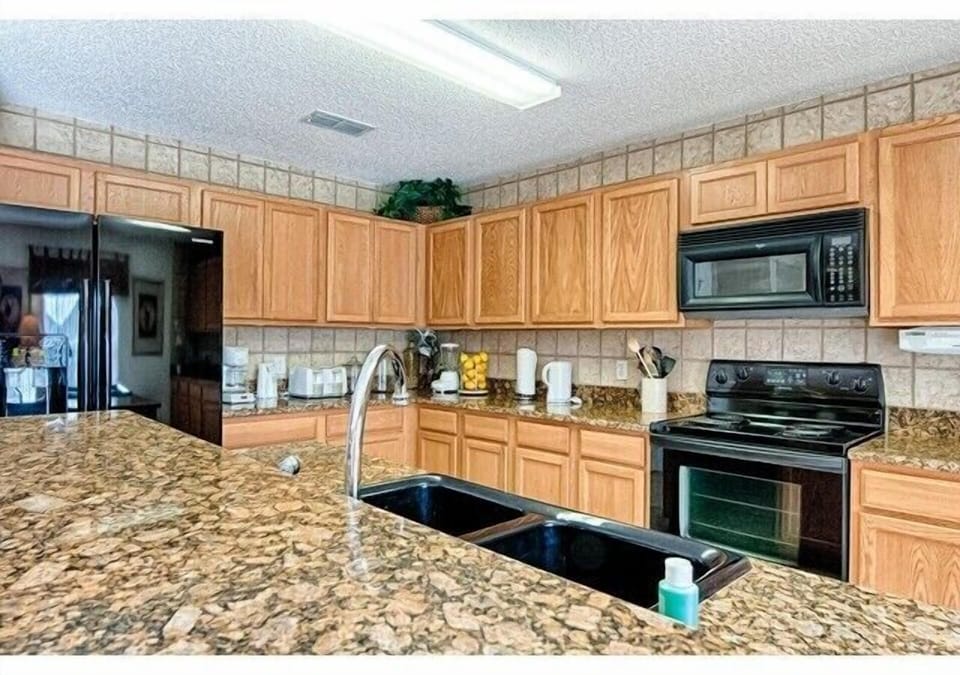 Fully equipped kitchen with a refrig. ice maker, deep sink, granite counter tops