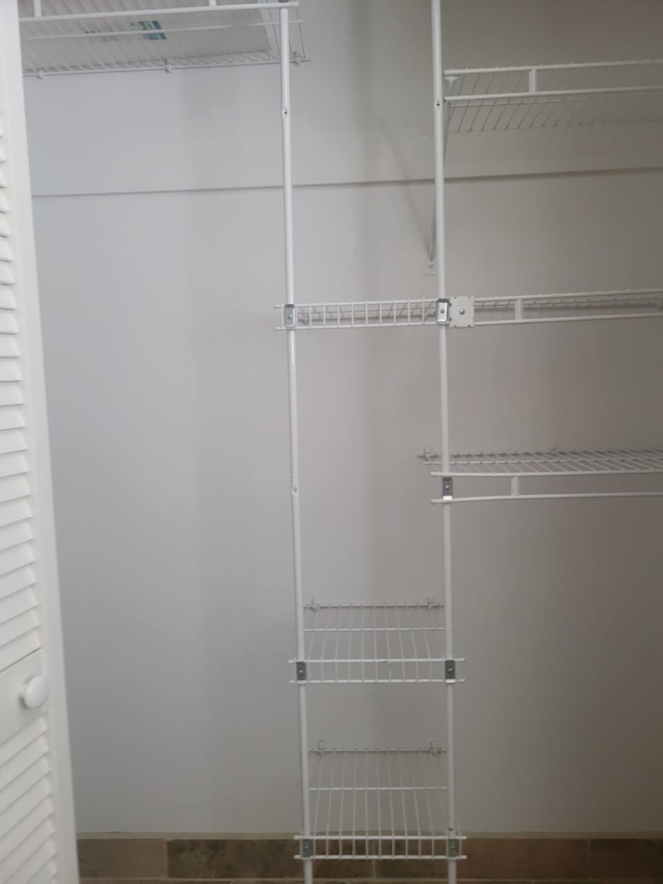 Sizable closet with shelving unit in 2nd bedroom with queen bed.
