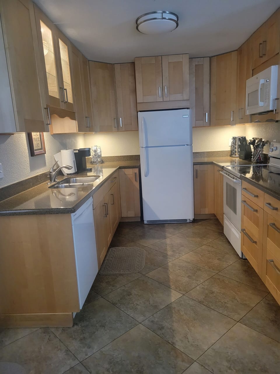 Fridge, dishwasher, electric stove, and Keurig coffee maker.