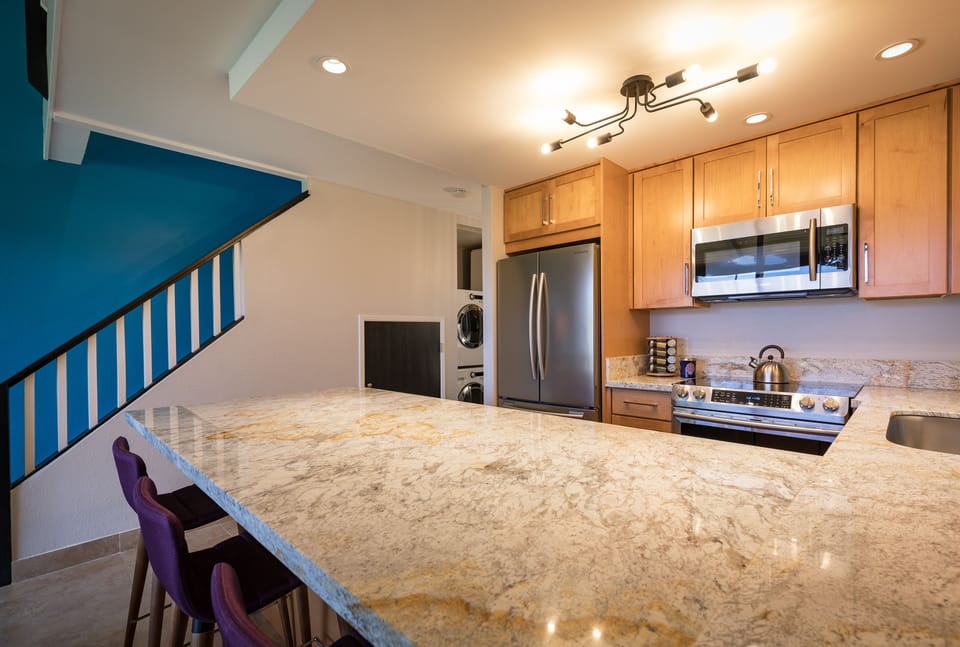 Large gourmet kitchen with stainless steel appliances.