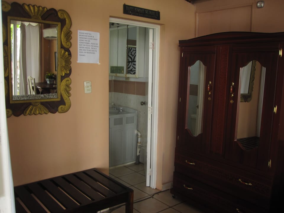 Glass room with Queen bed, closet, rack for suitcase off full bathroom