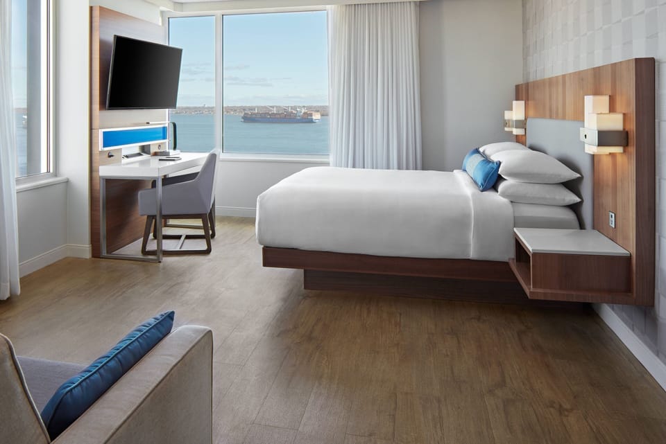Premium bedding, desk, laptop workspace, blackout drapes