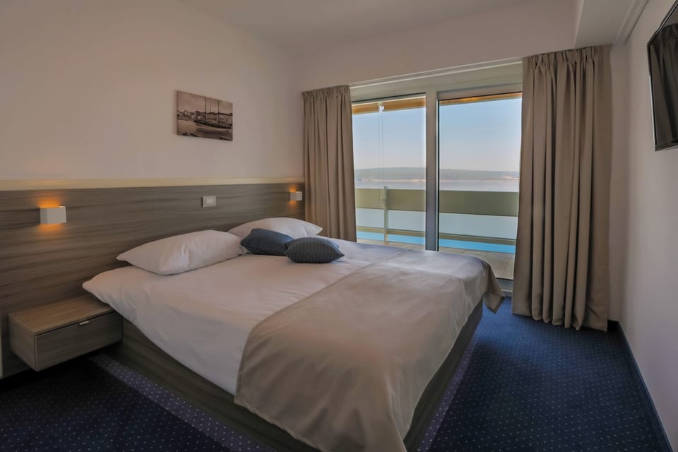 Suite, sea view, two balconies | Minibar, in-room safe, desk, blackout drapes