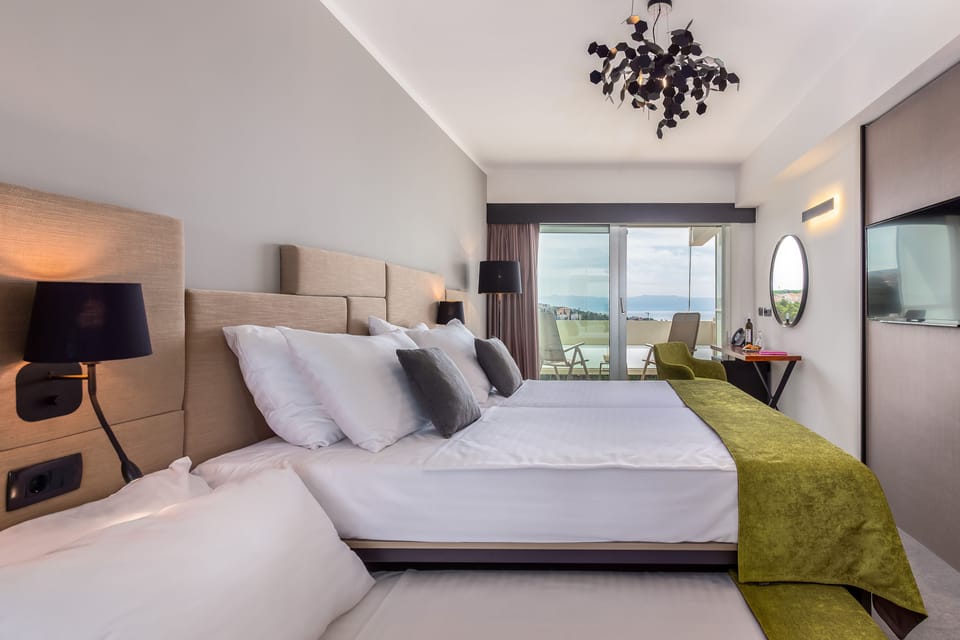 Superior Twin Room, Partial Sea View | Minibar, in-room safe, desk, blackout drapes