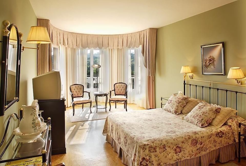 Desk, laptop workspace, iron/ironing board, bed sheets