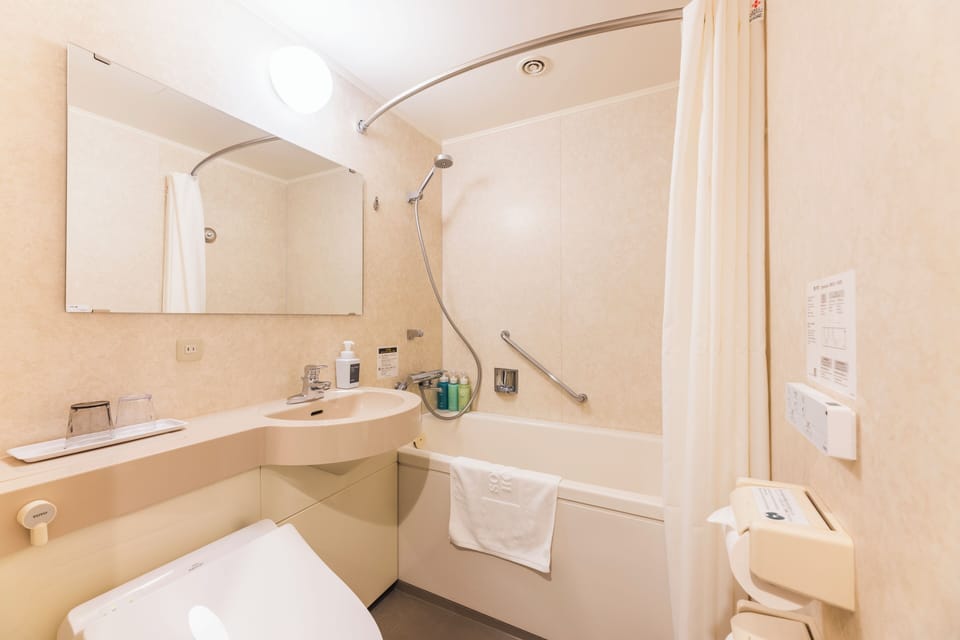 Combined shower/tub, free toiletries, hair dryer, slippers