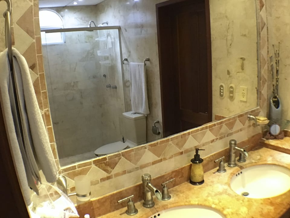 Large walk-in marble shower with 
rain shower head.