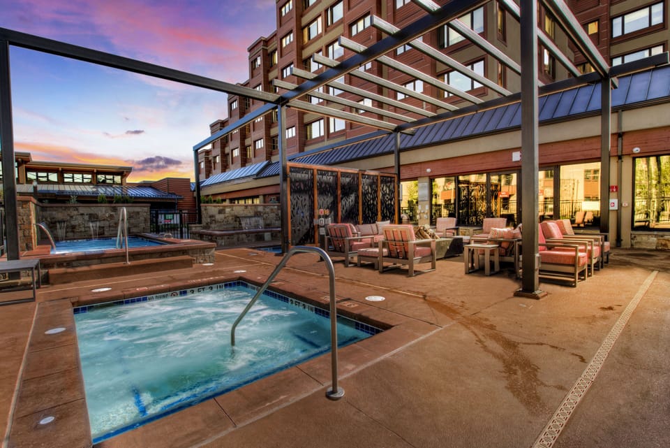 Hot tubs and pool in same building as unit.