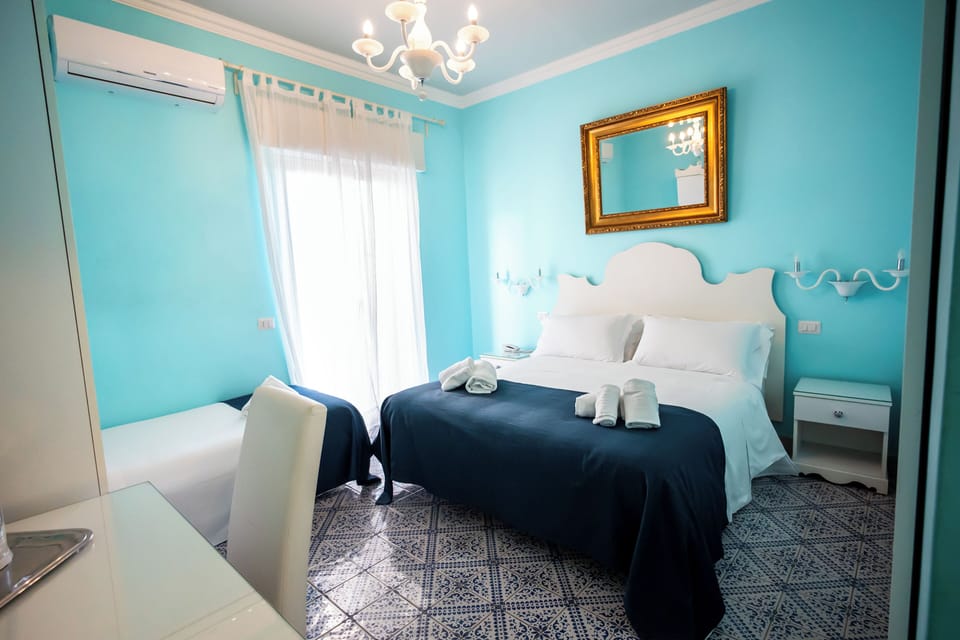 Triple Room | Minibar, in-room safe, desk, iron/ironing board