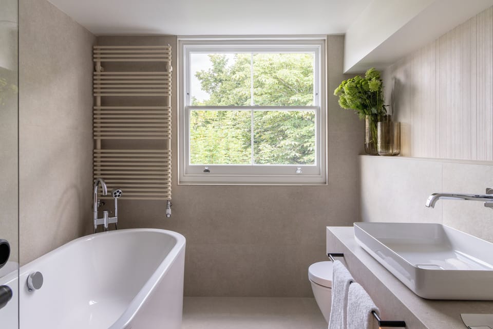 Deluxe | Bathroom | Designer toiletries, hair dryer, slippers, towels