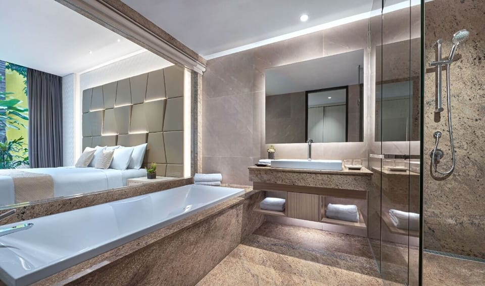 Deluxe Plus | Bathroom | Shower, free toiletries, hair dryer, slippers