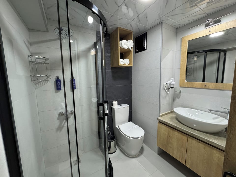 Shower, hair dryer, slippers, towels