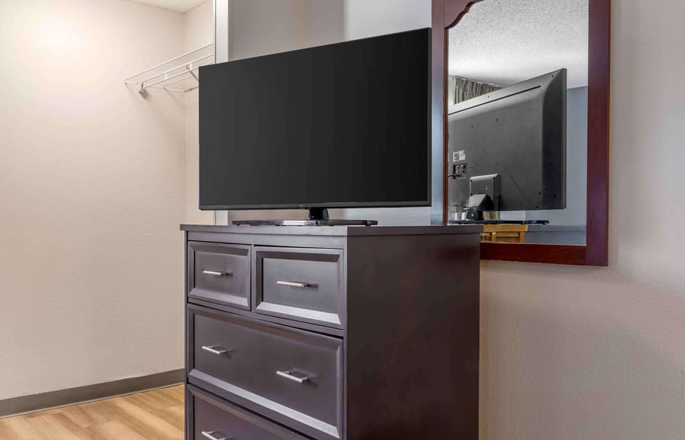 Desk, laptop workspace, blackout drapes, iron/ironing board