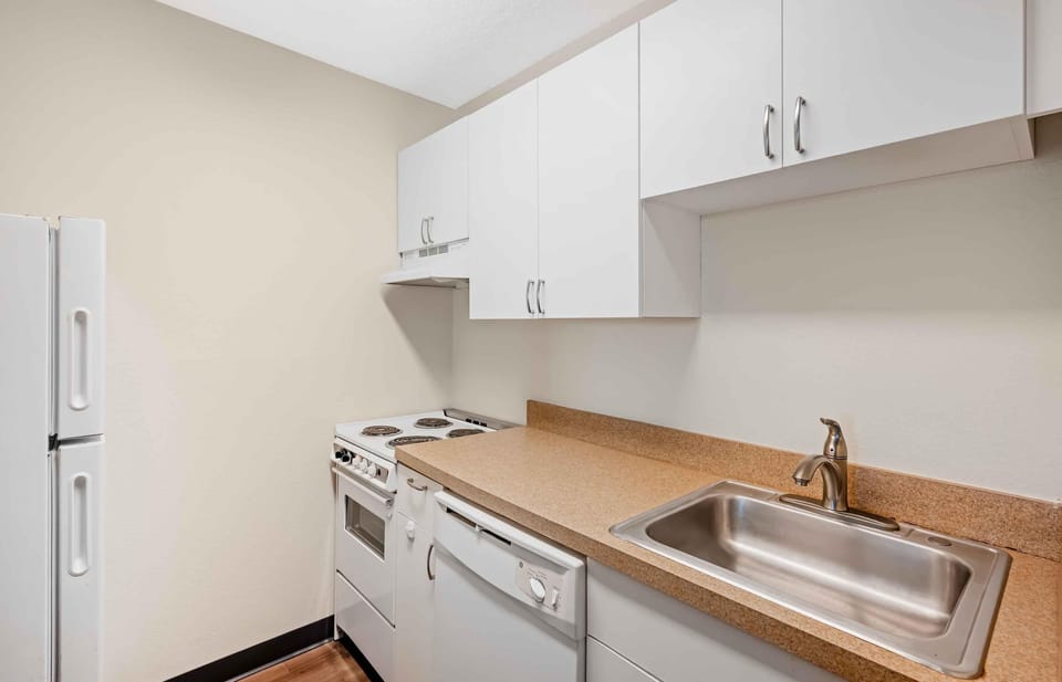 Full-size fridge, microwave, stovetop, cookware/dishes/utensils