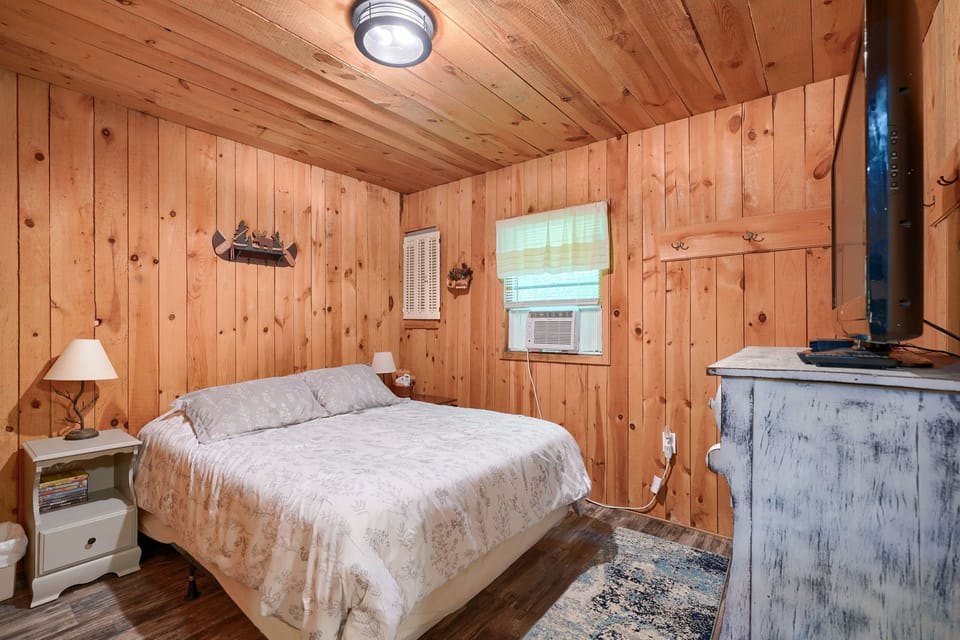 bedroom with queen bed and TV