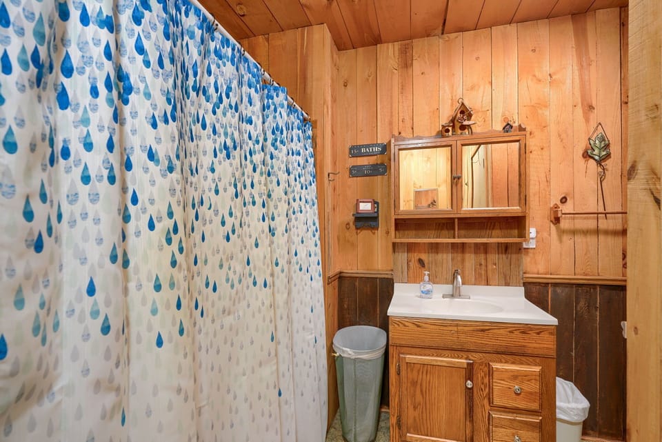 full bath with tub/shower combo, toilet is just out of view on right