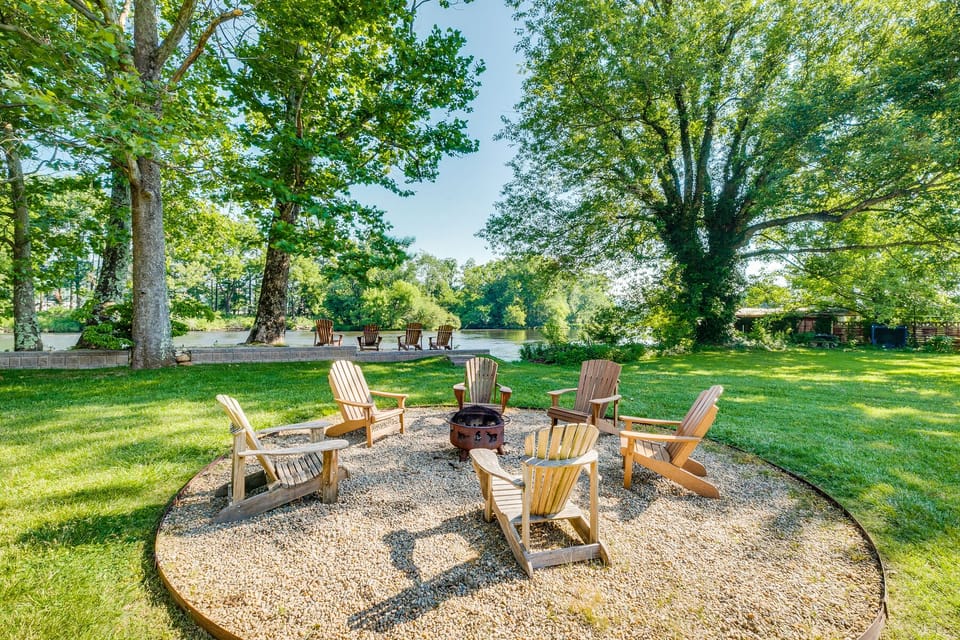 Back yard Oasis! Featuring a wood fire pit and wall right on the rivers edge!