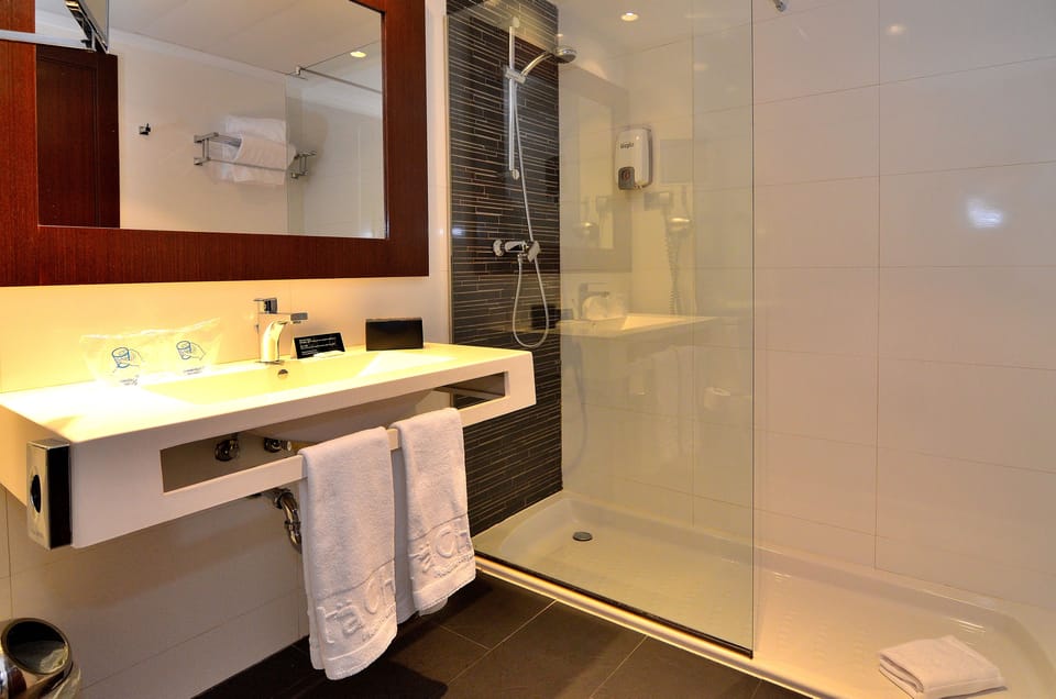 Shower, designer toiletries, hair dryer, slippers