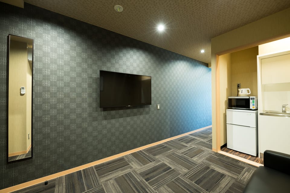 Junior Suite - Shiki Suites | Kyoto Umekoji | Living area | 55-inch flat-screen TV with digital channels, TV