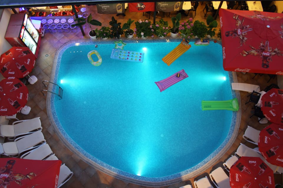 Seasonal outdoor pool, open 7 AM to midnight, pool umbrellas