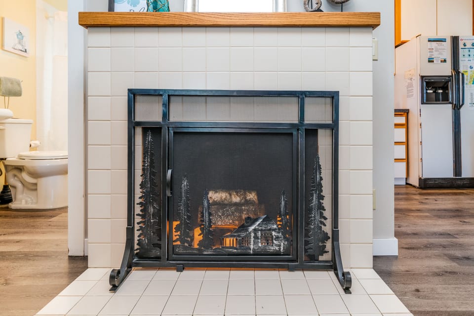 Battery operated candle-lit fireplace adds ambience to the space