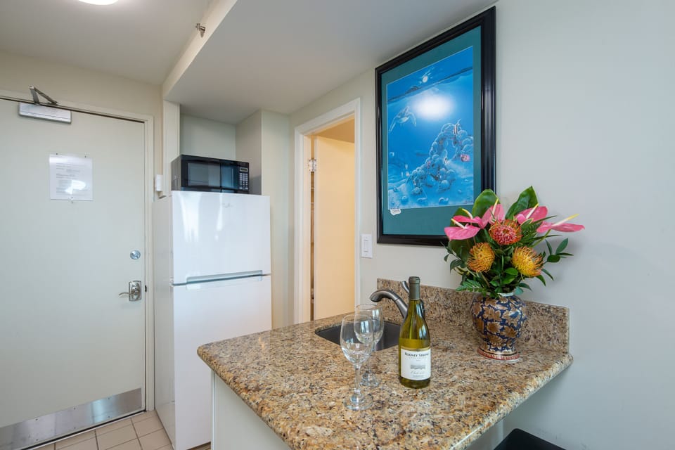 Kitchen comes with microwave,  coffee pot, toaster, full size refrigerator, induction hot plate, pots and pans
