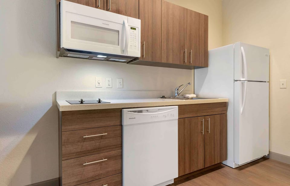 Studio, 1 Queen Bed, Non Smoking | Private kitchen | Full-size fridge, microwave, stovetop, cookware/dishes/utensils