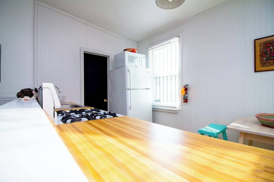 Bright, open kitchen with warm wood counters, full appliances, and natural light—clean, functional, and easy to enjoy.
