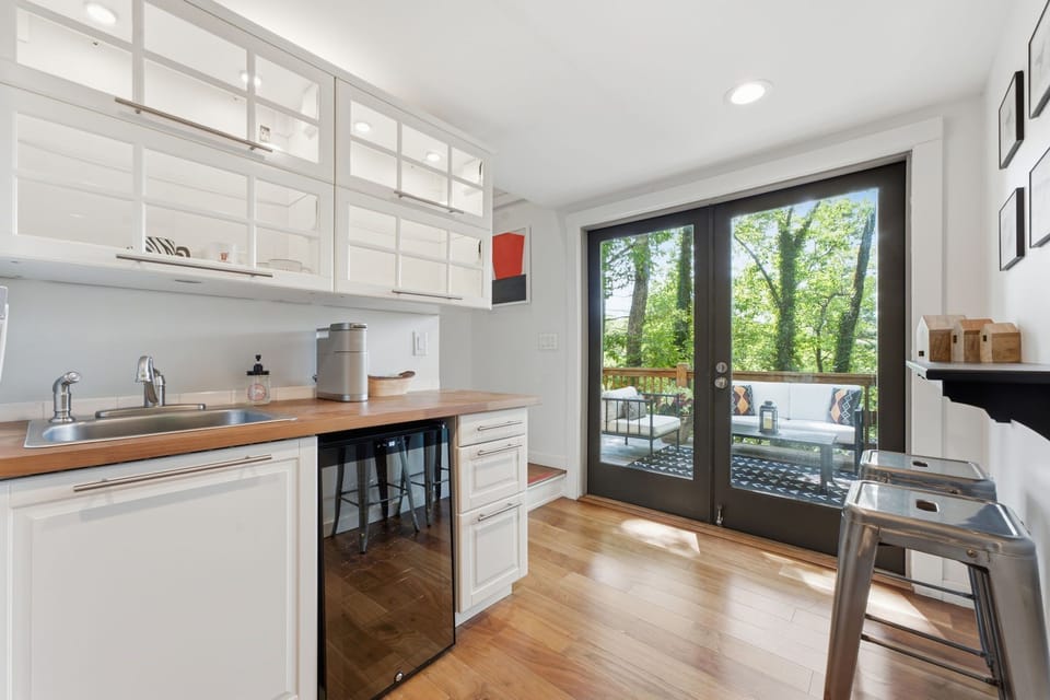Lower level wet bar with wine cooler and Keurig coffee maker. 