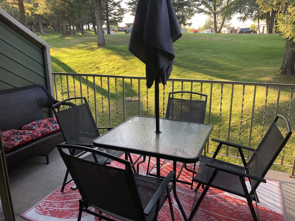 Patio looking onto green space and view of the mountains 