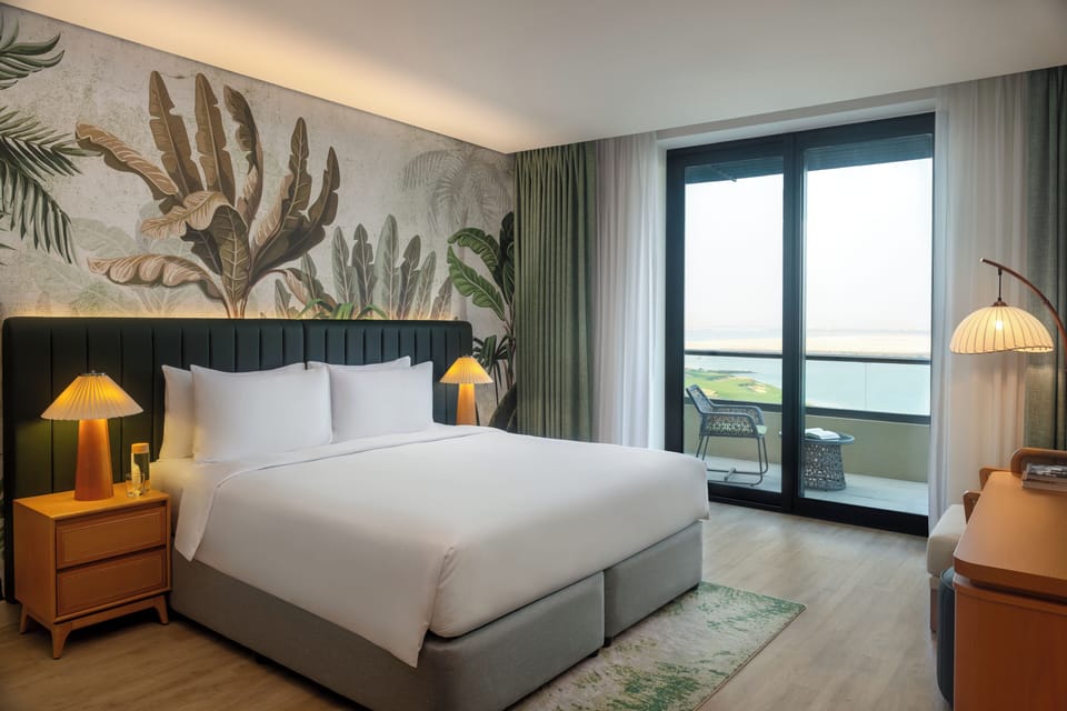 1 King Deluxe Sea View Balcony Theme Park Access | Premium bedding, minibar, in-room safe, individually decorated