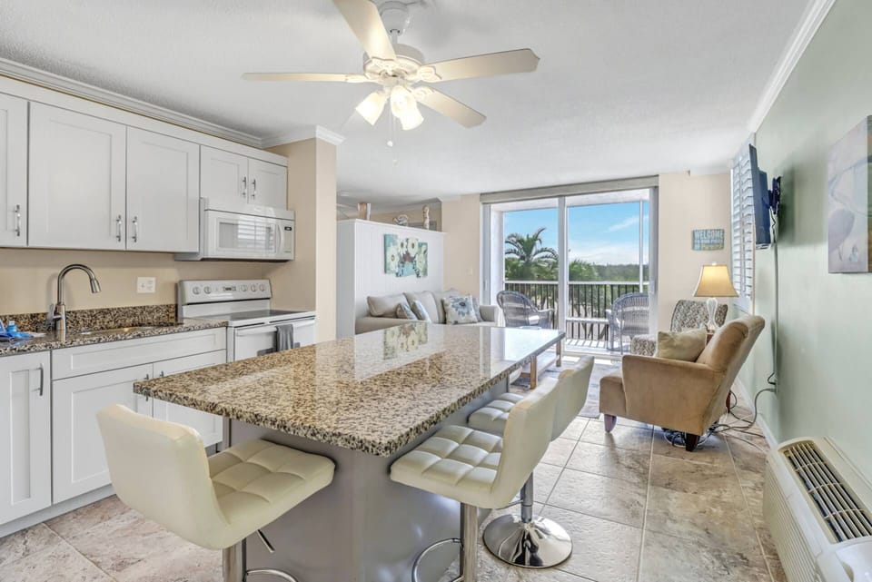The open concept main living area including living room, dining and beautifully remodeled kitchen.
