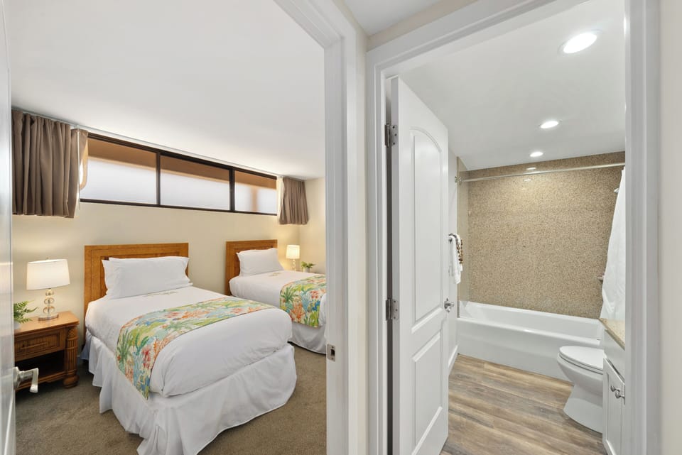 Guest bedroom with sunlit convertible twin beds that easily form a king, highlighted by decorative touches and a warm, inviting atmosphere