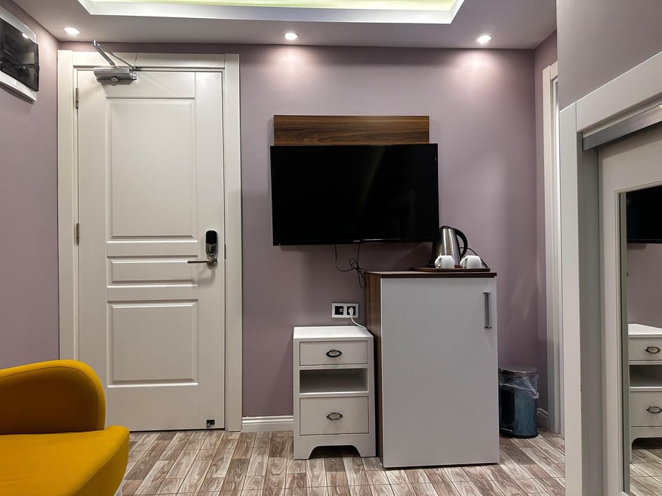 Standard Triple Room | Living area | 82-cm LCD TV with premium channels, TV