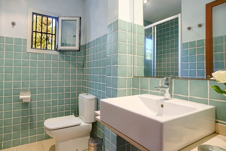 Master bedroom en-suite bathroom with toilet, sink and shower