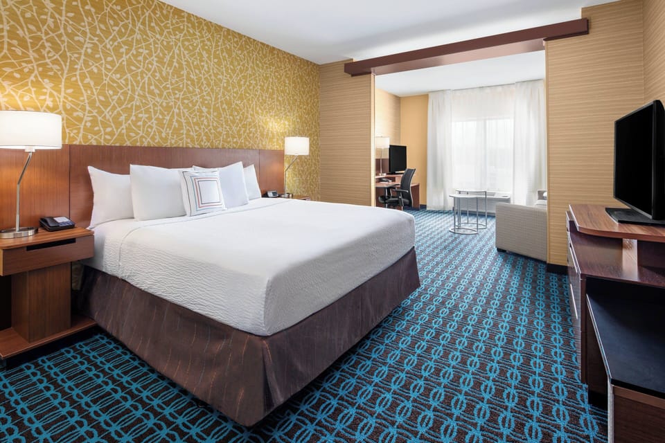 Hypo-allergenic bedding, desk, laptop workspace, blackout drapes